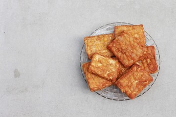 Tempeh, Tempe Goreng or Fried tempeh is Indonesia traditional food, made from fermented soybean seeds.