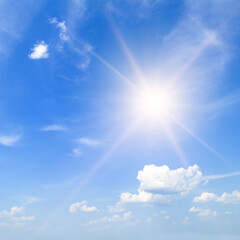 Naklejka na ściany i meble bright sun, blue sky and light clouds.