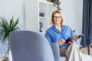 Professional Psychotherapy online. Middle aged female Psychologist having video call consultation...