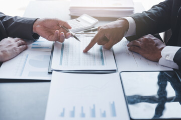 Finance and investment concept, Businessman present business finance investment plan with his partner, Investor colleagues discussing new investment plan by financial graph data on office table 