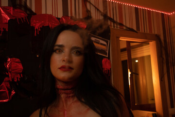 European Halloween party in a friends apartment- -Images of Young adults celebrating Halloween. Brunette girl smokes