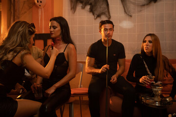 European Halloween party in a friends apartment- Friends get make up in an apartment -Images of...