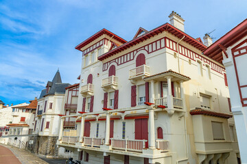 Red and white basque houses on the seaside of the Promenade Jacques Thibaud in Saint-Jean-de-Luz, France