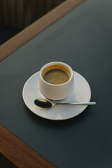 Cup of black coffee on a table in a cafe. .