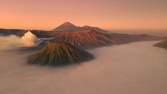 Sunrise at Mount Bromo, is an active volcano in Tengger Semeru National Park, East Java, Indonesia. Aerial drone view 4K.