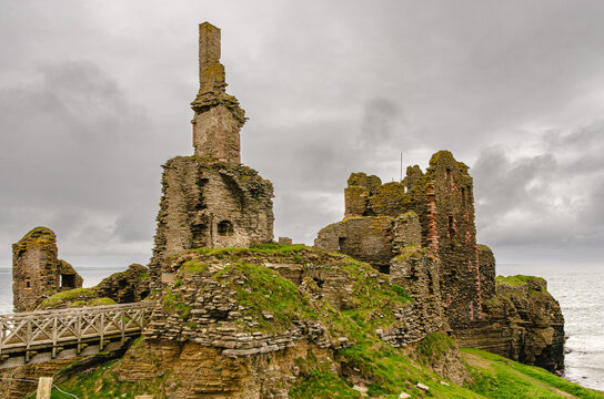 Ruins of a Castle Sinclair Girnigoe in Scotland. Beautiful stone structure built on a fin of rock. Overcast weather.