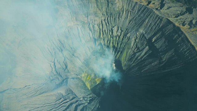 Dramatic view inside the crater and caldera of Mount Gunung Bromo an active somma volcano, Bromo Tengger Semeru National Park, East Java, Indonesia. Aerial drone view 4K.