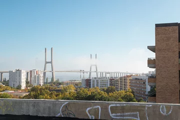 Photo sur Plexiglas Pont Vasco da Gama Buildings with the river and Vasco da Gama bridge on the background
