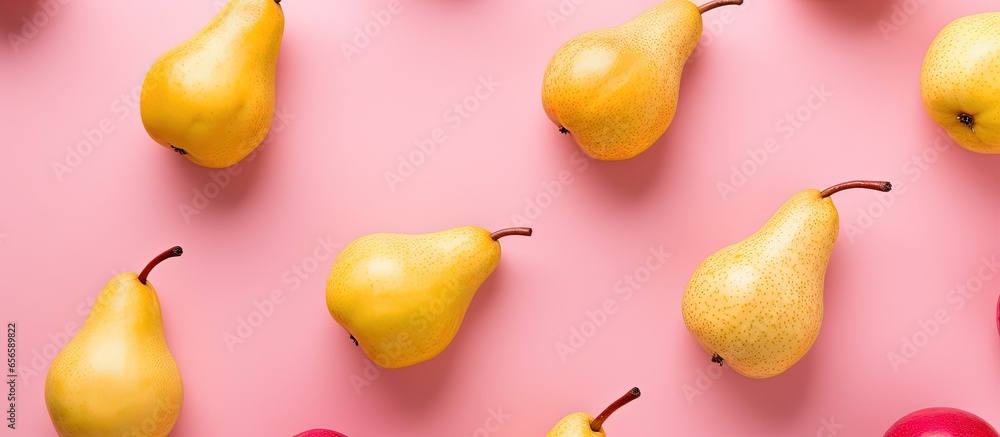 Poster top view of fresh pears arranged on a pink background with a vibrant fruit pattern with copyspace fo