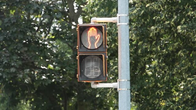 crosswalk walk walking dont walk hand stop red symbol traffic light direction of hand digital electric electronic yellow black on post road street
