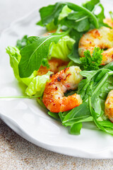 fresh shrimp salad prawn seafood shrimps, arugula appetizer meal food snack on the table copy space food background rustic top view 