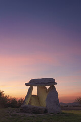 The dolmen of Sorginetxe illuminated at sunset, is a funerary monument located in the province of...