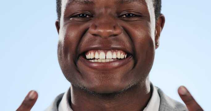 Man, smile and pointing at teeth in studio closeup, oral hygiene and dentistry or dental care. Happy black person, portrait and mockup of orthodontics, clean or whitening treatment on blue background