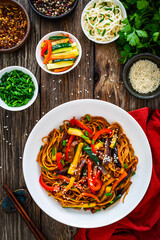 Korean style stir fried vegetables and noodles on wooden table

