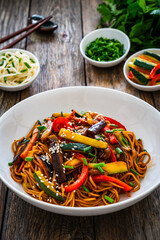 Korean style stir fried vegetables and noodles on wooden table
