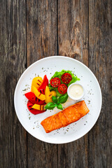 Seared salmon steak with grilled bell pepper and mayonnaise on wooden table
