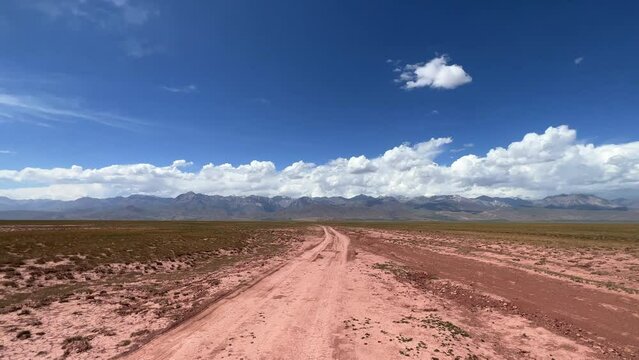 The Alai Valley is drowned in clouds, and the road leads to the base camps of Lenin Peak. An inter-mountain depression in the Pamir-Alay mountain system in the Osh region of Kyrgyzstan. 4К