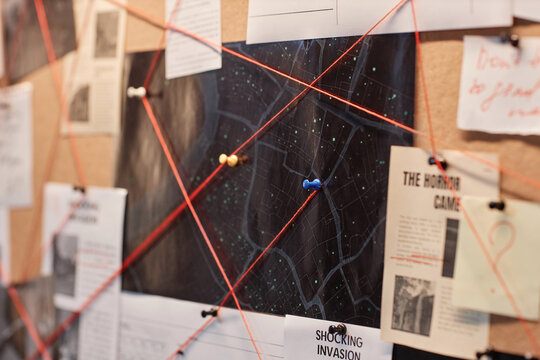 Closeup background image of evidence board with red thread connecting map and pictures, copy space