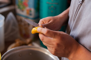 Photo of hands peeling Olluco. Concept of food and traditions in Peru.