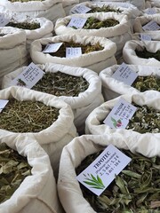 Dried medicinal herbs kept in canvas bags sold in the market