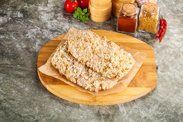 Breaded raw breaded meat schnitzel