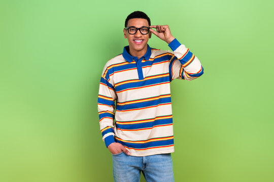 Photo of touching new gucci glasses guy striped stylish polo shirt candid model posing business manager isolated on green color background