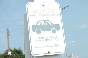 notice extreme temperature can be fatal please check do not leave valuables in the car sign on post...
