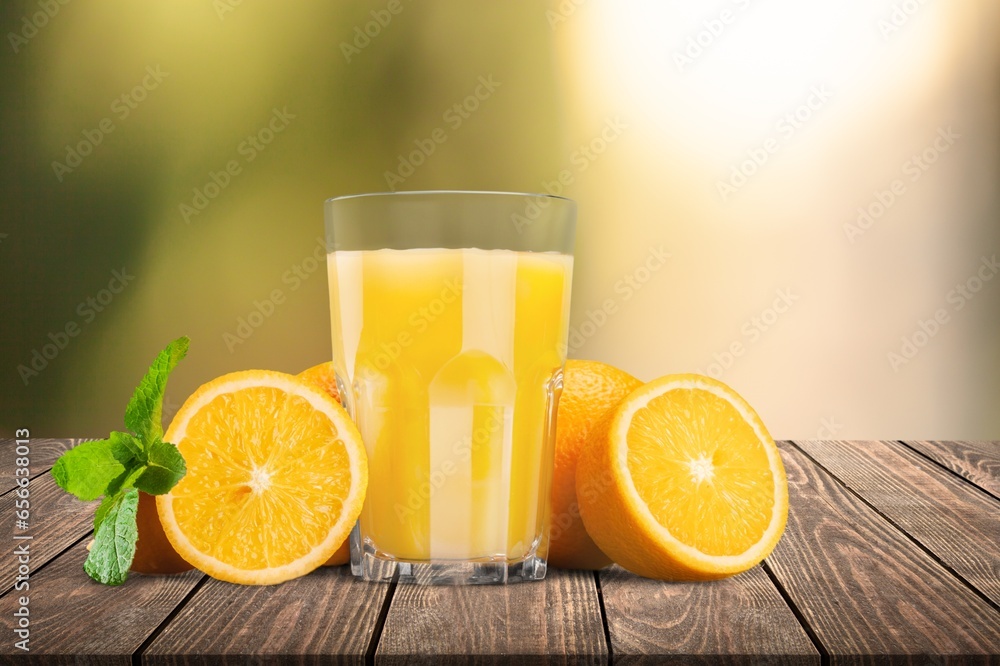 Poster Fresh sweet orange juice in glass on table