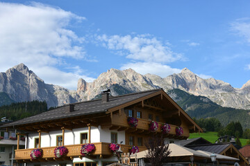 traditional with flowers decorated farmhouse with wooden balconies in the Austrian village of Maria...
