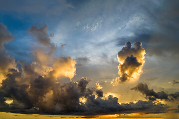 Colofrul clouds brightly illuninated by setting sun on evening sky. Changing cloudscape weather at...