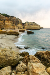Rocky cliffs on sandy Marinha Beach in Algarve coast at Atlantic Ocean in Portugal