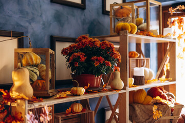 Pumpkin decorations with hay, baskets, and cozy chair place