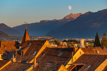 Beautiful waning moon over the old city of Rapperswil, Canton St. Gallen, Switzerland.