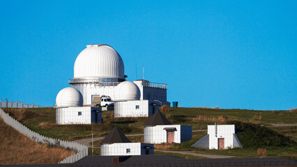 Observatory on a mountain plateau against the blue sky. Copy space.