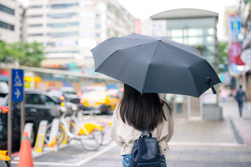 Woman hold with black umbrella at Taipei city