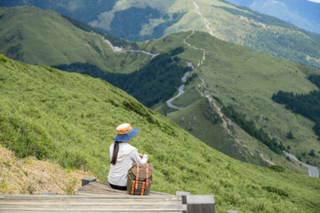 Fototapeta na wymiar Asian woman hiker rest on the mountain