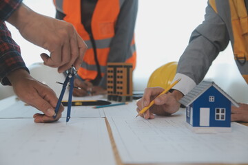 Construction and structure concept of Engineer or architect meeting for project working with partner and engineering tools on model building and blueprint in working site, contract for both companies.