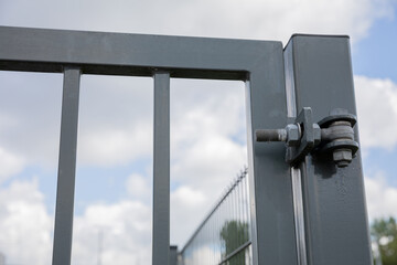 A close-up view of the steel hinge from the fence gate.