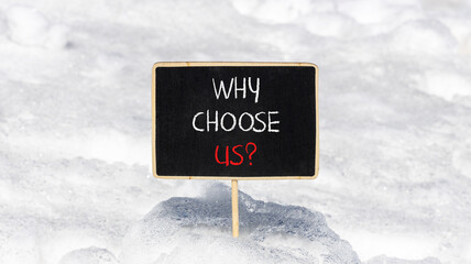 Why choose us symbol. Concept word Why choose us on beautiful wooden black chalk blackboard. White snow. Beautiful white snow background. Business motivational why choose us concept. Copy space.