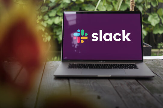 Slack logo, a cloud-based freemium cross-platform instant messaging service, displayed on a MacBook Pro screen