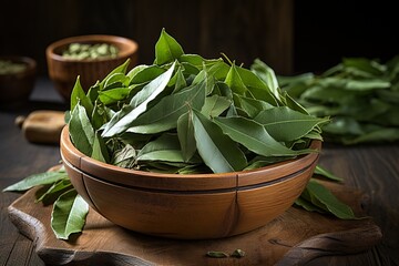 closeup bowl with dried bay leaves on wooden background - obrazy, fototapety, plakaty