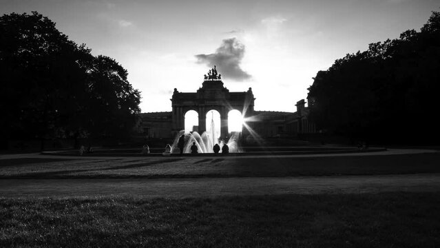 Romantic lovers silhouette black and white sunset time lapse of the Cinquantenaire Park the lights turning Colours of sunset night in the Arcades du Cinquantenaire noir and vintage french architect