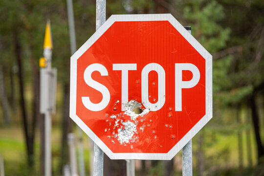 Stop road sign shot broken with a shotgun