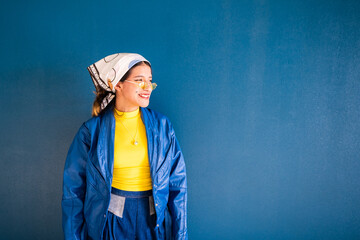 fashionable young mexican woman smiles looking to the right side with copy-space