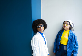 Young afro mexican man and a young woman looking direct to the camera. Concept of fashionable people with copy-space