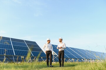 Project manager discuss with worker installation process of solar panel