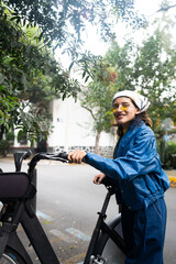 Young mexican woman takes her rental bike from the parking station lot at Mexico City