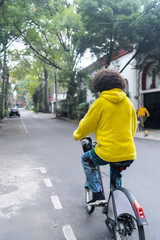 Unrecognizable young man riding on a rented bicycle at the street in Mexico City