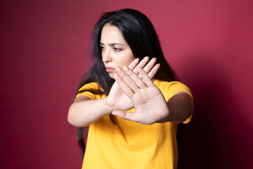woman with stop sign on color background