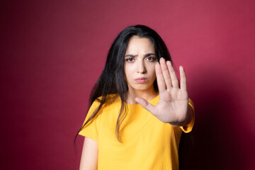 woman with stop sign on color background
